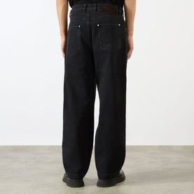Model wearing Emporium Stitch Wide Leg Jeans in black. Rear view showing wide-leg fit, five-pocket style and suede backtab detail.