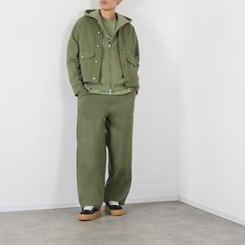 Model wearing Emporium Thermal Logo Hoodie in khaki, styled with matching khaki jacket and wide-leg trousers, black and tan trainers.