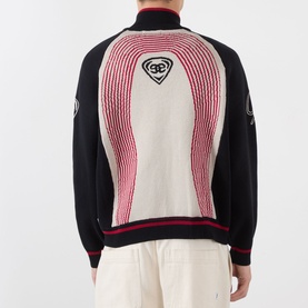 Model wearing Emporium E90 Logo Knitted Zip Sweater in navy, back view showing red and cream jacquard knit panel and embroidered logo