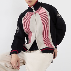 Model wearing Emporium E90 Logo Knitted Zip Sweater in navy, featuring red jacquard knit panel, funnel collar and double zip fastening, styled with