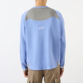 Model wearing Emporium Henry Logo Knitted Sweater in baby blue with grey contrast yoke panel and small logo detail, back view, styled with beige