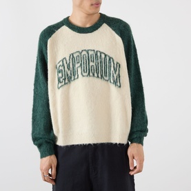 Model wearing Emporium Logo Mohair Sweater in green, cream body with green raglan sleeves, brushed finish and varsity-style logo lettering across