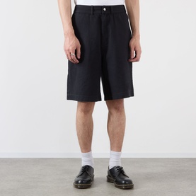 Model wearing Emporium Double-Pocket Shorts in black, mid-rise straight-leg knee-length fit, styled with white socks and black leather shoes.