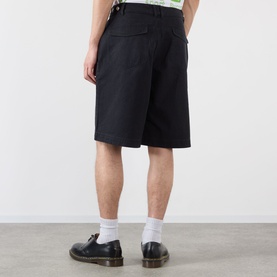 Model wearing Emporium Double-Pocket Shorts in black, knee-length straight-leg fit with rear flap pockets, styled with white socks and black shoes.