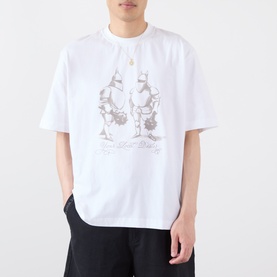 Model wearing Emporium Armour Logo T-Shirt in white with taupe armour screen-print graphic, styled with black trousers.