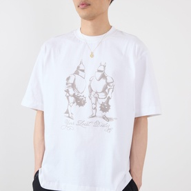 Model wearing Emporium Armour Logo T-Shirt in white with grey knight graphic print, styled with black trousers and gold necklace.