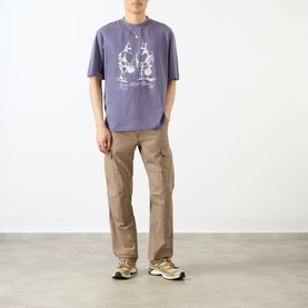 Model wearing Emporium Armour Logo T-Shirt in burgundy with front graphic print, styled with tan cargo trousers and chunky trainers.