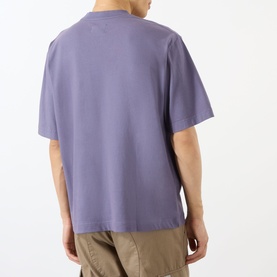 Model wearing Emporium Armour Logo T-Shirt in Burgundy, rear view, relaxed fit, short sleeves, styled with khaki trousers.