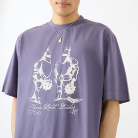 Model wearing Emporium Armour Logo T-Shirt in burgundy with front screen-print graphic of two armoured figures, styled with a pendant necklace.