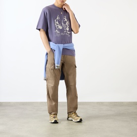 Model wearing Emporium Armour Logo T-Shirt in burgundy with front graphic print, styled with tan cargo trousers and a tied blue shirt.