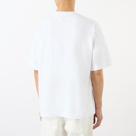 Model wearing Emporium EE Logo T-Shirt in white, back view, relaxed fit with dropped shoulders and short sleeves, styled with white trousers.