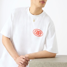 Model wearing Emporium EE Logo T-Shirt in white with red contrast chest logo, crew neck, short sleeves; styled with a gold pendant necklace.