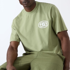 Model wearing Emporium EE Logo T-Shirt in khaki with white chest logo print, styled with matching khaki joggers.