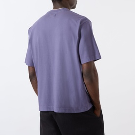 Model wearing Emporium burgundy cotton T-shirt, rear view, with black trousers visible.