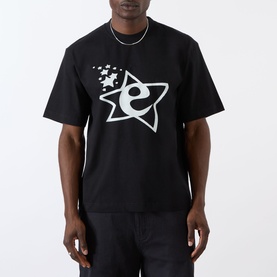 Model wearing Emporium Lucky Stars Logo T-Shirt in black, featuring large star and 'e' screenprint graphic, boxy fit, short sleeves, with silver