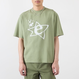 Model wearing Emporium Lucky Stars Logo T-Shirt in khaki green with white star and logo screenprint, styled with khaki trousers.