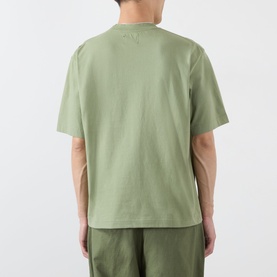 Model wearing Emporium Lucky Stars Logo T-Shirt in khaki green, rear view showing boxy fit, short sleeves and back screenprint graphic, styled with