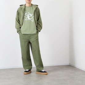 Model wearing Emporium Lucky Stars Logo T-Shirt in khaki green, styled with matching khaki hoodie and trousers, black gum-sole trainers.