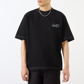 Model wearing Emporium Script Logo T-Shirt in black with embroidered logo and contrast stitching, styled with a silver chain necklace.