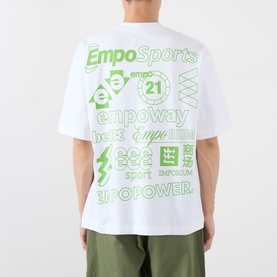 Model wearing Emporium There'll Be Signs Logo T-Shirt in white, back view showing green all-over logo screenprint graphics, styled with khaki