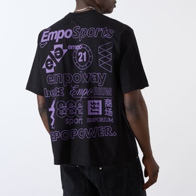 Model wearing Emporium There'll Be Signs Logo T-Shirt in black, showing back with purple multi-logo screenprint graphics and crew neckline.