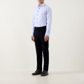 Model wearing Eterna blue cotton formal shirt with single cuff, styled with navy trousers and black dress shoes