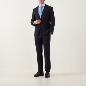 Model wearing Eterna blue single cuff regular cotton formal shirt, styled with navy suit and black Oxford shoes.