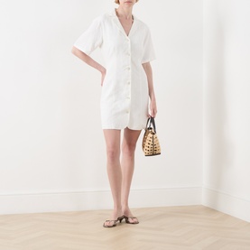Model wearing Fabienne Chapot Melody Mini Shirt Dress in Cosy White with notch collar and short sleeves, styled with woven bag and tan sandals