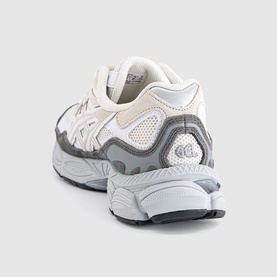 Chunky trainer in cream and grey with mesh panels, grey rubber outsole, and tonal lace-up fastening, shown from rear angle