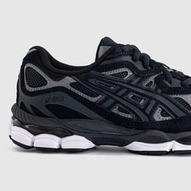 Asics trainer in graphite grey and black, featuring mesh upper with branded side stripe and chunky white sole.