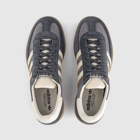 Adidas grey and off-white suede trainers, overhead view showing cream three-stripe detail, gum-effect sole and branded tongue label.