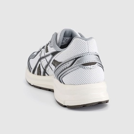 Asics trainer in white and black, rear three-quarter view showing mesh upper, dark overlays, and cream chunky sole.