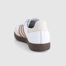 Adidas Samba trainer in white with cardboard stripe detailing, cream heel tab, and dark gum sole, rear three-quarter view.