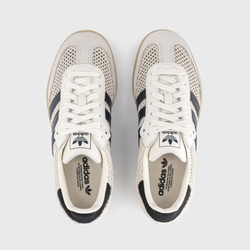 Adidas trainers in off-white and carbon with gold metallic detail, perforated leather upper, dark three stripes, cream gum sole, top-down view.