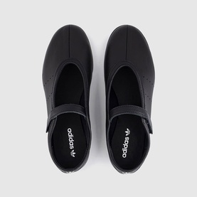 Adidas black flat shoes with velcro strap fastening, cream white branding on insole, top-down view