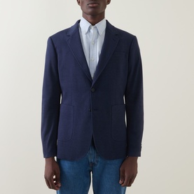 Model wearing Gant Patch Pocket Single-Breasted Blazer in evening blue, styled with a striped shirt and blue jeans.