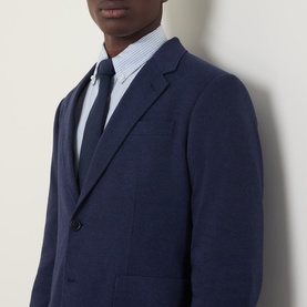 Model wearing Gant Patch Pocket Single-Breasted Blazer in Evening Blue, styled with a light blue striped shirt and navy tie.