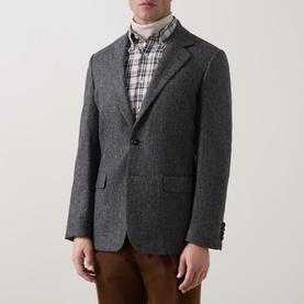 Model wearing Gant black grey herringbone blazer, styled with plaid shirt, turtleneck and brown trousers