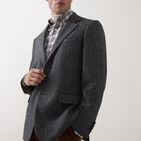 Model wearing Gant black grey herringbone blazer, styled with plaid shirt and roll-neck jumper, burgundy trousers visible