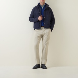 Model wearing Gant Evening Blue casual jacket, styled with blue knit, beige trousers and black loafers