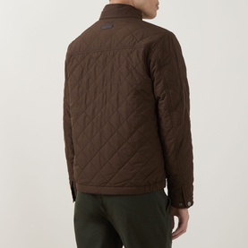 Model wearing Gant Classic Quilted Jacket in black brown, rear view, showing diamond quilted texture, funnel neck and snap-buttoned cuffs