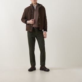 Model wearing Gant Classic Quilted Jacket in black brown with dark green trousers and dark brown lace-up shoes.