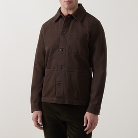 Model wearing Gant Black Brown cotton casual jacket with button front, chest pocket, and lower patch pockets, styled with dark trousers