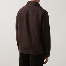 Model wearing Gant Black Brown cotton casual jacket, rear view showing collar and tonal branding detail, styled with dark trousers