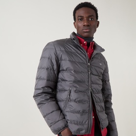 Model wearing Gant Casual Jacket in Dusky Anthracite, quilted puffer style with zip front, styled with a red shirt underneath.