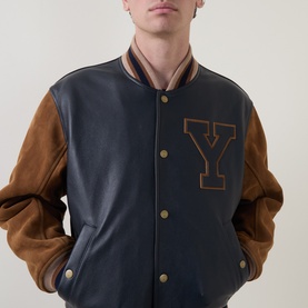 Model wearing Gant Varsity Logo Leather Bomber Jacket in navy, with tan leather sleeves, Y letter patch, and ribbed trims
