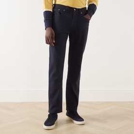 Model wearing Gant 3049 Jeans in Evening Blue, straight leg fit, styled with a yellow top and navy trainers