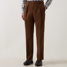 Model wearing Gant Mahogany Brown wool casual trousers with double pleats, styled with a check shirt and dark leather loafers.
