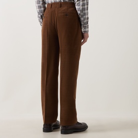 Model wearing Gant Mahogany Brown wool casual trousers, styled with a check shirt and black leather shoes, rear view.