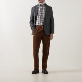 Model wearing Gant Mahogany Brown wool casual trousers, styled with a grey blazer, check shirt and dark loafers.
